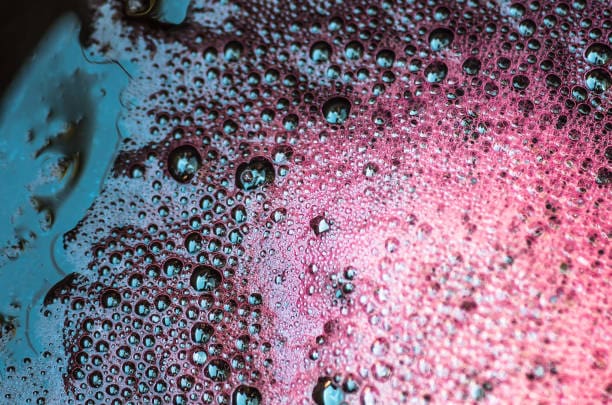 Bubbles the wort red wine during fermentation, closeup, background