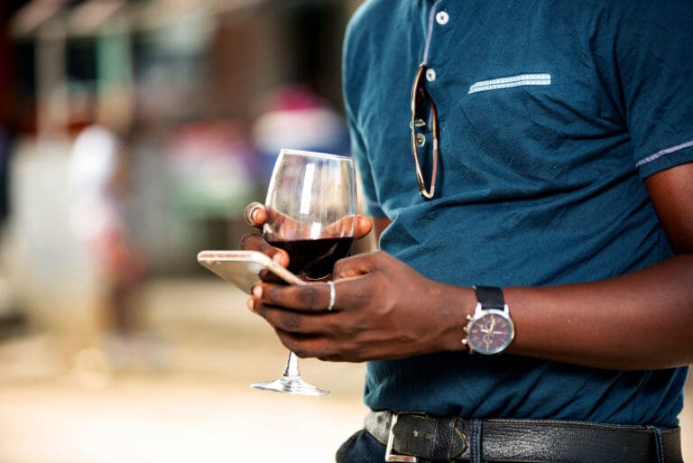 Handsome,Young,African,Man,Standing,Holding,A,Glass,Of,Red