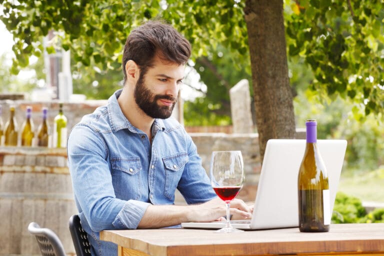 Portrait,Of,Young,Winemaker,Sitting,At,Wine,Cellar,In,Front