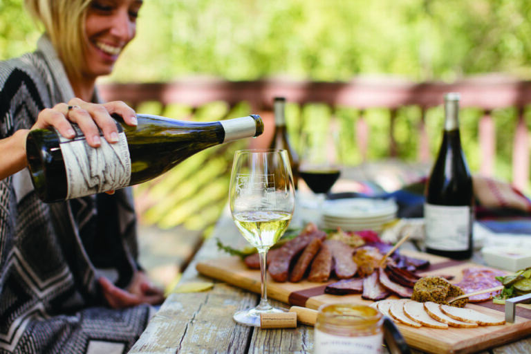 A glass of white wine is poured for a meal at Page Springs Cellars tasting room in Cornville, AZ