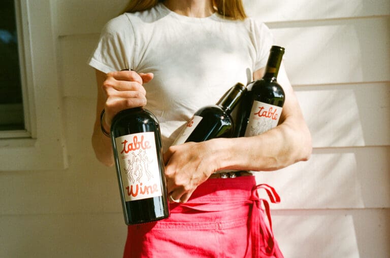 Table-Wine-bottles-in-arms-horizontal